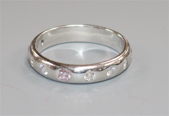 A modern 18ct white gold and gypsy set nine stone diamond ring, size N.